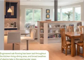  ??  ?? Engineered oak flooring has been laid throughout the kitchen-living-dining area, and broad swathes of glazing take in the spectacula­r views