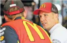  ?? ASSOCIATED PRESS FILE PHOTO ?? Jamie McMurray, right, talks to a crew member before practice for the All-Star Race in May at Charlotte Motor Speedway.