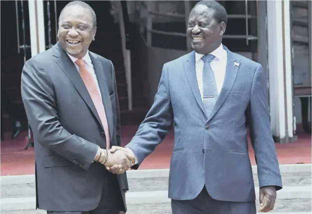  ?? PICTURE: SIMON MAINA/AFP/GETTY IMAGES ?? Kenya’s president Uhuru Kenyatta, left, shakes hands with the National Super Alliance coalition opposition leader Raila Odinga