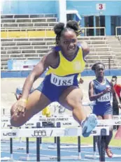  ?? (Photo: Dwayne Richards) ?? Alexia Austin of Glengoffe High School on her way to clocking a new record 14.52 seconds to erase the 11-year-old Class Two girls’ 100m hurdles record of 14.74 seconds set by Felecia Ferron of Morant Bay High in 2010.