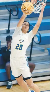  ?? STEPHEN M. DOWELL/ORLANDO SENTINEL PHOTOS ?? OCP junior Isaiah Brown dunks against Mount Dora Christian Academy in a region semifinal victory Friday night. Brown led all scorers with 17 points.