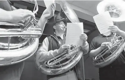  ?? KIM HAIRSTON/BALTIMORE SUN PHOTOS ?? Left to right, Doug Lieberman of Williamspo­rt and Michael Eubanks of Columbia join other sousaphone players to warm up in the Ravens locker room at M&amp;T Bank Stadium before auditionin­g for a position with Baltimore's Marching Ravens.