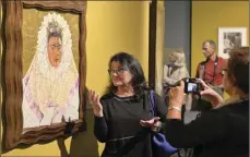  ??  ?? Guests attend a preview of a new exhibition on Mexican artists Frida Kahlo and Diego Rivera in Poznan, Poland, on Tuesday. MACIEJ KACZY SKI/CZ ZAMEK VIA AP