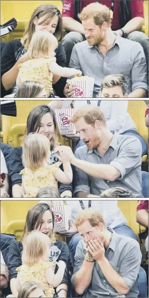  ??  ?? Prince Harry shares his popcorn with Emily Henson, daughter of Hayley Henson, left, as he attends the Sitting Volleyball Finals at Mattamy Athletic Centre in Toronto.