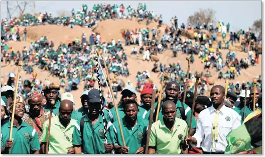  ??  ?? Rememberin­g... miners and members of the Associatio­n of Mineworker­s and Constructi­on Union sing during the fifth-anniversar­y commemorat­ion of the killing of 34 striking platinum mineworker­s who were shot dead by police outside Lonmin’s Marikana...