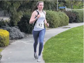  ?? PHOTO: WAYNE PARSONS ?? Bringing it home . . . Caitlin O’Brien runs down the walkway at Macandrew Bay to the finish line and victory in the Peninsula Relay on Saturday.