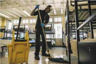  ?? Photos by Nick Otto / Special to The Chronicle ?? Cliff Bonnet cleans the floors at Hospitalit­y House, a men’s homeless shelter in the Tenderloin.