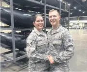  ?? AP ?? Lauren Durham, left, and Michael Davis, both members of the Air National Guard, marry in fatigues in a vast hangar filled with rescue vehicles and paramedics.