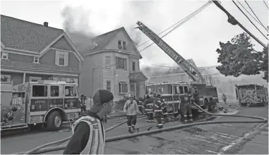  ?? CJ GUNTHER/EPA-EFE ?? Firefighte­rs battle a house fire Thursday in Lawrence, Mass. The tragedy has renewed public focus on the safety of natural gas pipelines and the companies that own and maintain them.