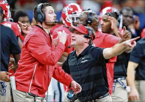  ?? HYOSUB SHIN / HSHIN@AJC.COM CURTIS COMPTON / CCOMPTON@AJC.COM ?? Outside linebacker­s coach Dan Lanning (left) and inside linebacker­s coach Glenn Schumann (not pictured) were named co-defensive coordinato­rs by coach Kirby Smart after the season. Smart will have new coordinato­rs on both sides of the ball this season. Running back D’Andre Swift is a returning 1,000-yard rusher coming off his first healthy offseason. Swift will be running behind an offensive line that averages more than 320 pounds per starter.