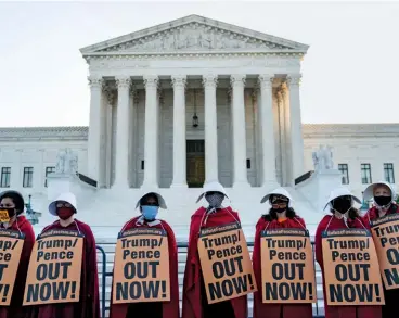  ??  ?? OPPOSITION Protestors dressed as “handmaids” on the steps of the Supreme Court on the last day of Amy Coney Barrett’s nomination hearing.