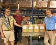  ??  ?? Aspiring Eagle Scout Jack McElhenney, of Pennsylvan­ia, made a trip to Central New York to purchase flatware for homeless veterans as part of his culminatin­g service project. From left, Jack, and Sherrill Manufactur­ing owners Matt Roberts and Greg Owens...