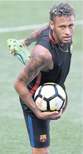  ??  ?? Barcelona’s Neymar stretches during a training session in Harrison, New Jersey.