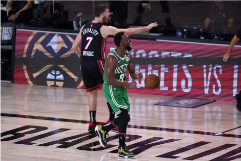  ?? (AP Photo/Mark J. Terrill) ?? Boston Celtics guard Kemba Walker (8) celebrates forcing a turnover against Miami Heat's Goran Dragic (7) during the second half of an NBA conference final playoff basketball game, Saturday, Sept. 19, 2020, in Lake Buena Vista, Fla.