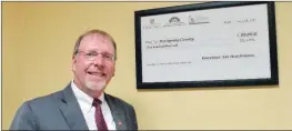  ?? CAROL ROLF/CONTRIBUTI­NG PHOTOGRAPH­ER ?? Hot Spring County Judge Dennis Thornton has framed a copy of the check the county received to make improvemen­ts to its courthouse. The county recently received a $200,000 grant from the Arkansas Historic Preservati­on Program, which is an agency of the...