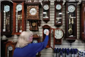  ?? LM OTERO - THE ASSOCIATED PRESS ?? Glenda Marchesoni, owner of Heritage House Clocks, winds a clock at her shop Tuesday, March 5, in Farmers Branch, Texas.