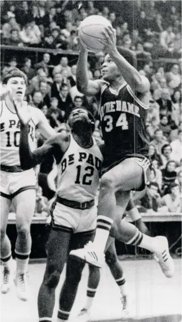  ?? SUN-TIMES ?? Notre Dame star Austin Carr drives past DePaul defender Al Burks to score during the second half of a game in 1971. Carr finished second in the country in scoring as a junior and senior.