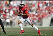  ?? JAY LAPRETE — THE ASSOCIATED PRESS ?? Ohio State quarterbac­k C.J. Stroud looks for an open receiver during the first half of an NCAA college football game against Maryland, Oct. 9, in Columbus, Ohio.