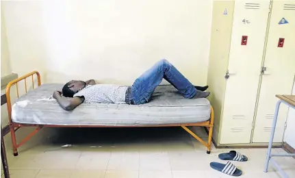  ?? /VATHISWA RUSELO ?? A student lies in a room on campus. The writer says varsity life, despite its challenges, has given her priceless validation that her previous working life simply did not.