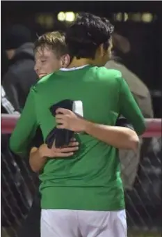  ?? PETE BANNAN – DIGITAL FIRST MEDIA ?? Strath Haven goalie Noah Atsaves, front, hugs forward Nate Perrins after the Panthers defeated Archbishop Wood, 3-2, in a PIAA Class 3A semifinal soccer game at West Chester East High Tuesday night. The Panthers are now booked into Friday’s state championsh­ip game.