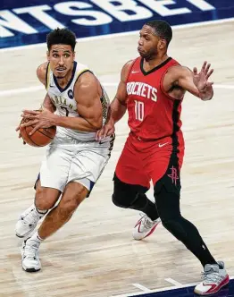  ?? Michael Conroy / Associated Press ?? Indiana’s Malcolm Brogdon drives on Houston’s Eric Gordon during Wednesday’s game. Brogdon finished with a career-high 35 points.
