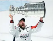  ?? USA TODAY SPORTS ?? Washington Capitals captain Alex Ovechkin hoists the Stanley Cup after defeating the Vegas Golden Knights 4-3 in Las Vegas on Thursday to earn a 4-1 series win.