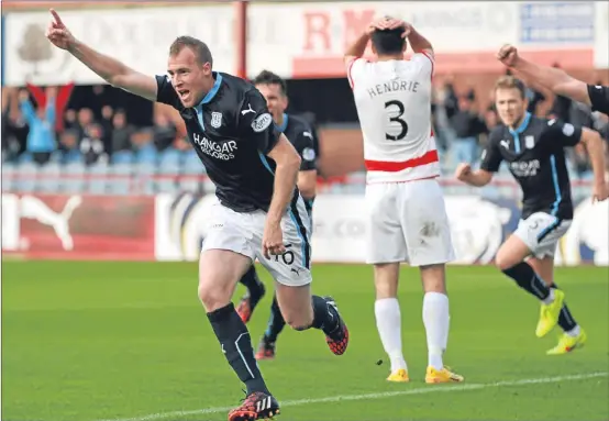  ??  ?? David Clarkson celebrates scoring his latest goal against Hamilton at Dens Park on Saturday.