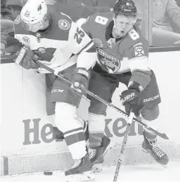  ?? WILFREDO LEE/AP ?? Wild defenseman Jonas Brodin (25) and Panthers center Jayce Hawryluk battle for the puck during the third period March 8 in Sunrise.