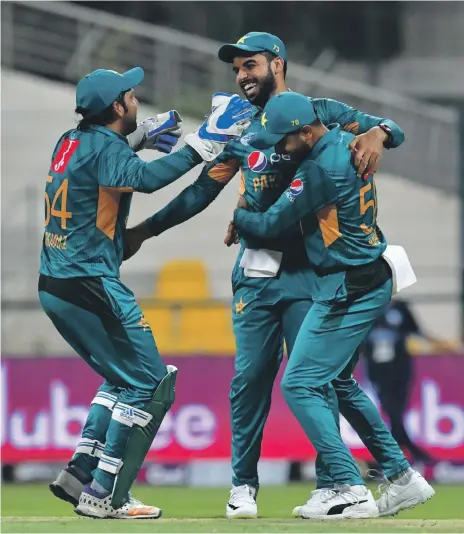  ?? AFP ?? Pakistan players celebrate after the dismissal of New Zealand batsman Colin de Grandhomme on Friday in Dubai while captain Sarfraz Ahmed, below, says the fact that his side is well balanced has been key to their T20 success