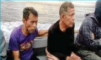  ??  ?? A Philippine military photo released to the regional newspaper Mindanao Examiner shows Malaysian sailors Tayudin Anjut, 45, and Abdurahim bin Sumas, 62, shortly after troops recovered them in the town of Kalingalan­g Caluang town in Sulu province.
