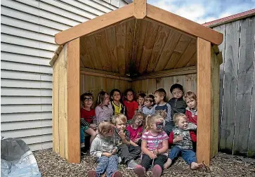  ?? WARWICK SMITH/STUFF ?? A new whare unveiled for Park Rd Playcentre’s children. 75th anniversar­y proves popular with the