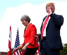  ?? — Reuters photo ?? Britain’s Prime Minister May and US President Trump walk away after holding a joint news conference at Chequers, the official country residence of the Prime Minister, near Aylesbury, Britain.