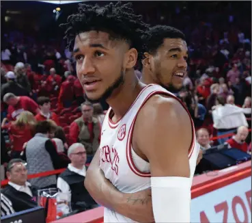  ?? (NWA Democrat-Gazette/Andy Shupe) ?? Arkansas sophomore guard Isaiah Joe (left) and junior guard Mason Jones embrace after the Razorbacks’ victory over Missouri on Feb. 22. Razorbacks Coach Eric Musselman said Thursday that he isn’t sure if Joe or Jones will declare for the NBA Draft or return next season.