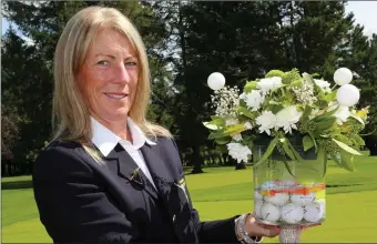  ??  ?? Kanturk Golf Club Lady Captain Deirdre Sheehan pictured holding a golf themed floral display on Lady Captain’s Day at the Club.
