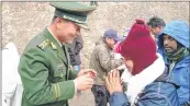  ??  ?? A Chinese officer greets the 2016 batch of Kailash Mansarovar pilgrims at Taklakot in China. File photo