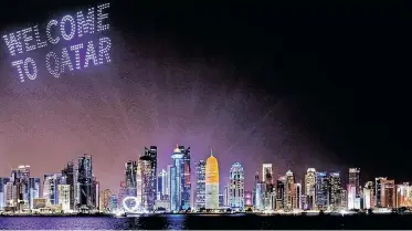  ?? | REUTERS ?? A DRONE show with welcoming words is seen above the Doha skyline, before the football World Cup 2022 in Qatar which started yesterday.