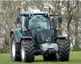  ??  ?? The Cambridges in County Durham: Prince William gets behind the wheel of farmer Stewart Chapman’s tractor, while
Kate and Stewart’s daughter Clover pat the lambs.