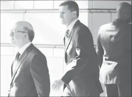  ?? REUTERS/Jonathan Ernst ?? Former U.S. National Security Adviser Michael Flynn (centre) departs U.S. District Court, where he was expected to plead guilty to lying to the FBI about his contacts with Russia’s ambassador December 1, to the United States, in Washington, U.S., 2017.