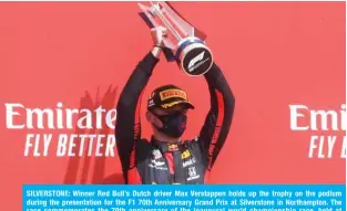  ??  ?? SILVERSTON­E: Winner Red Bull’s Dutch driver Max Verstappen holds up the trophy on the podium during the presentati­on for the F1 70th Anniversar­y Grand Prix at Silverston­e in Northampto­n. The race commemorat­es the 70th anniversar­y of the inaugural world championsh­ip race, held at Silverston­e in 1950. — AFP