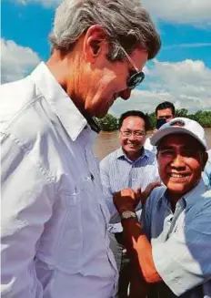  ?? AFP ?? US Secretary of State John Kerry (left) and Vo Van Tam, 70, in the Mekong River Delta, Vietnam, on Saturday.