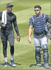  ?? KATHY WILLENS — THE ASSOCIATED PRESS ?? New York Yankees relief pitcher Aroldis Chapman, left, leaves the field after a bullpen session with catcher Gary Sanchez during a summer training camp workout on Sunday at Yankee Stadium in New York.