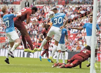  ??  ?? Liverpool’s German-born Cameroonia­n defender Joel Matip (second left) heads home from close range to make the score 1-1 in the English FA Community Shield football match between Manchester City and Liverpool on August 4. — AFP