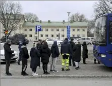  ?? Markku Ulander/Lehtikuva via AP ?? Police officers talk to family members of pupils at the Viertola school in Vantaa, Finland, on Tuesday. A shooting at the school killed a 12-year-old student. The suspect is the same age.