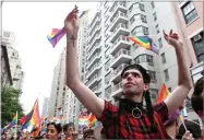  ?? TINA FINEBERG AP PHOTO BY ?? Participan­ts wave flags as they take part in the LGBTQ Pride march, Sunday, June 30, in New York.