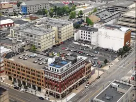  ?? CORNELIUS FROLIK / STAFF ?? An aerial view shows the corner of East Third and Jefferson streets. The Windsor Companies, which earlier this year took over redevelopm­ent of the Fire Blocks District, said it owns and controls the building at the corner (the Elks building, 100 E. Third St.) and the building next door (124 E. Third St.).