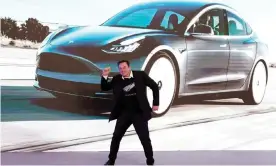  ?? Photograph: Aly Song/Reuters ?? Tesla CEO Elon Musk against a backdrop of one of the company’s electric cars.