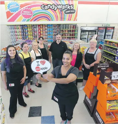  ?? JASON KRYK ?? Staff gather for a team photo as the new Red Apple store opens at 1905 Tecumseh Rd. W., the site of the old Bargain Shop.