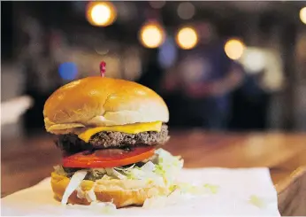  ?? THE ASSOCIATED PRESS ?? The creators of the Impossible Burger, made from plant protein, urge restaurant­s not to use the words vegan or vegetarian on menus when describing the burger.