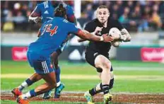  ?? AP ?? New Zealand’s TJ Perenara (right) runs into a tackle from France’s Teddy Thomas during the second Test in Wellington.