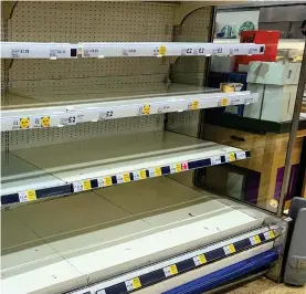  ??  ?? Stripped bare: An empty chiller display at a Tesco in Cambridge